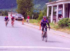 Scott Damman of Boulder, Colo., wins the sprint for the finish line in the Fort William A. Seward part of Haines to become the first solo rider to win the Kluane-Chilkat International Bike Relay (in 2003). In the background, Juneau riders Scott Fischer, left, and Dave Bartlett sprinted for second place.
